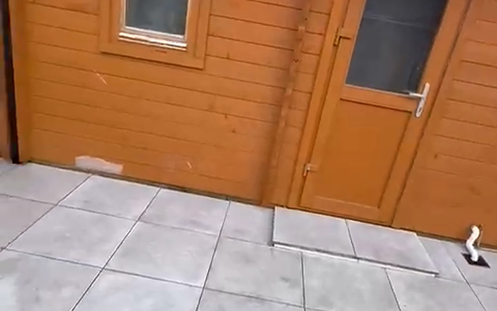 Tiled patio in front of the garden cabin after installation