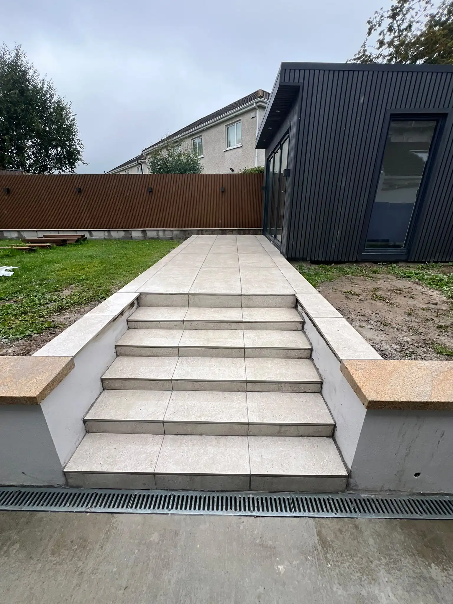 Tiled patio steps with granite-capped retaining walls