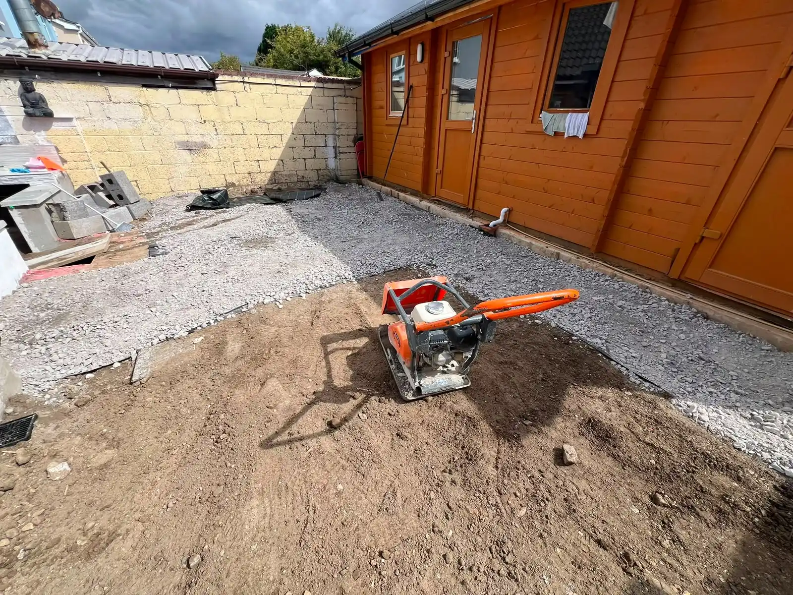 Patio sub-base being levelled and compacted