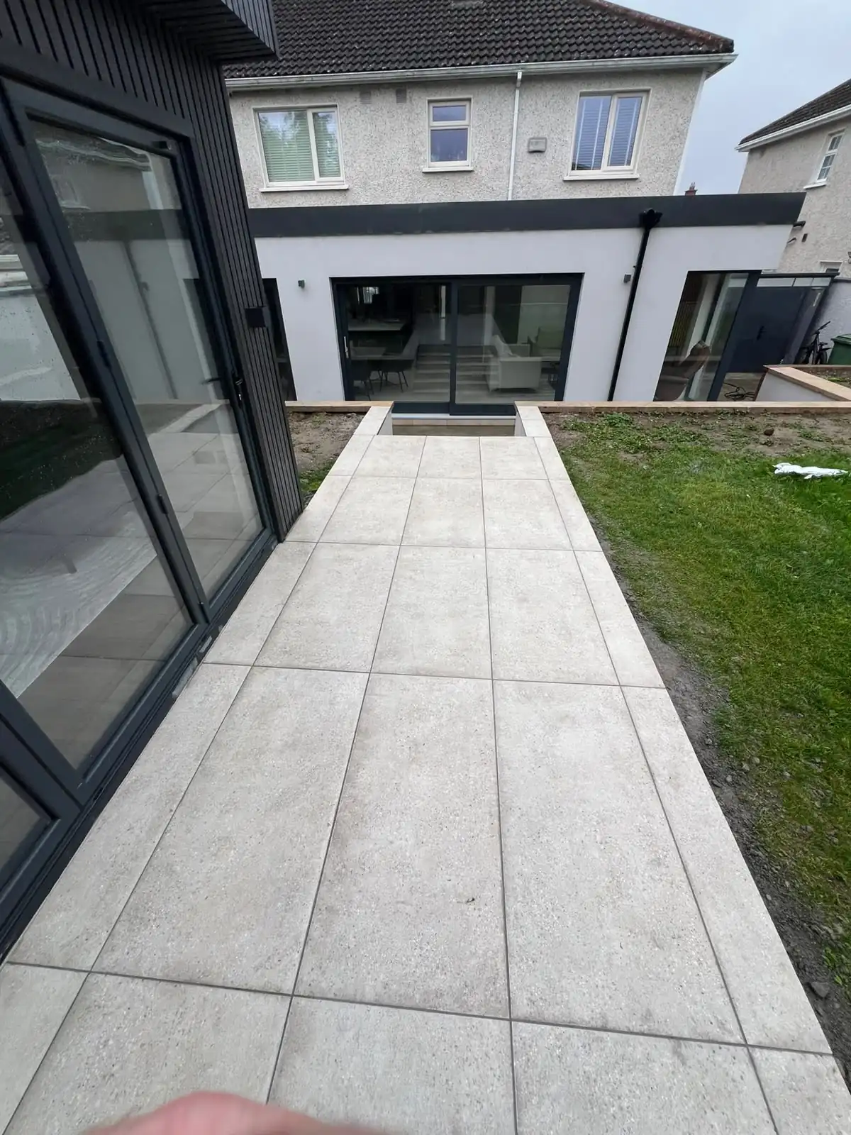 Porcelain tiled walkway running from the garden room back to the house